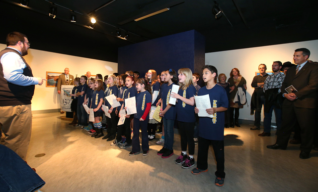 Gov. Brian Sandoval, far right, was among nearly 500 people who watched the Fremont Singers, from Fremont Elementary School in Carson City, sing Home Means Nevada at the grand opening event for th ...