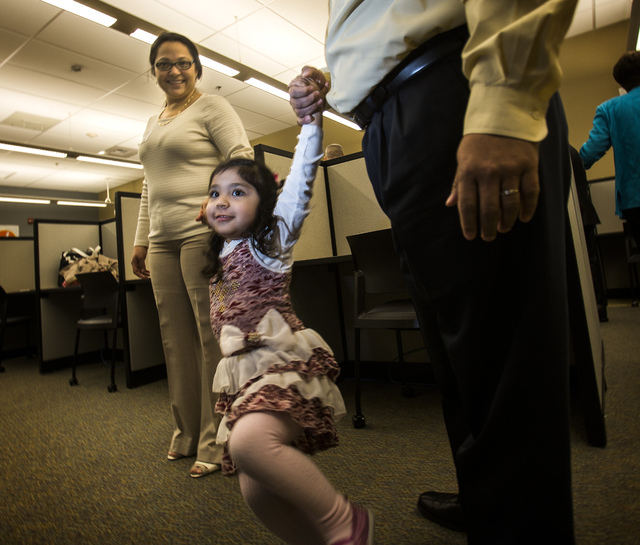 Mildred and Eddie Sigala hold their daughter, Mia, 3, during the ribbon-cutting Tuesday at the new community computer lab at Vegas PBS, 3050 E. Flamingo Road. Mildred Sigala took a dental assistan ...