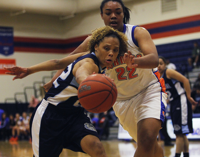 Centennial's Teirra Hicks (22) reaches for a loose ball against Bishop Gorman's Raychel Stanley (22) during their girl's basketball game in Las Vegas on Wednesday, Jan. 29, 2014. (Jason Bean/Las V ...