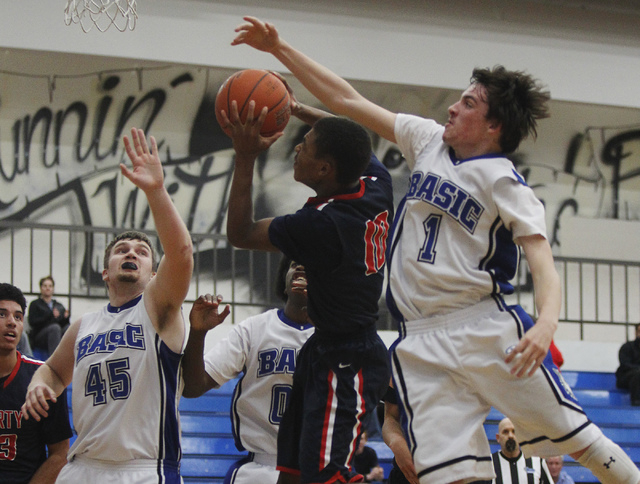 Basic's Jared Meacham (1) tries to block the shot of  Liberty's Jayven Hines-Stockton (10) during their basketball game in Henderson on Thursday, Jan. 30, 2014. (Jason Bean/Las Vegas Review-Journal)