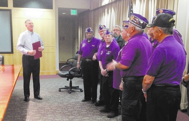 Mayor Andy Hafen, left, proclaims Henderson a Purple Heart City on Monday while members of Military Order of the Purple Heart Chapter 730 stand in the mayor's conference room. (Keith Rogers/Las Ve ...
