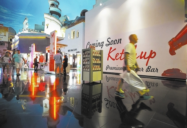 Shoppers walk past the future location of Ketchup Premium Burger Bar inside the Miracle Mile Shops at Planet Hollywood Resort and Casino on Thursday, Sept. 5, 2013. (Samantha Clemens/Las Vegas Rev ...