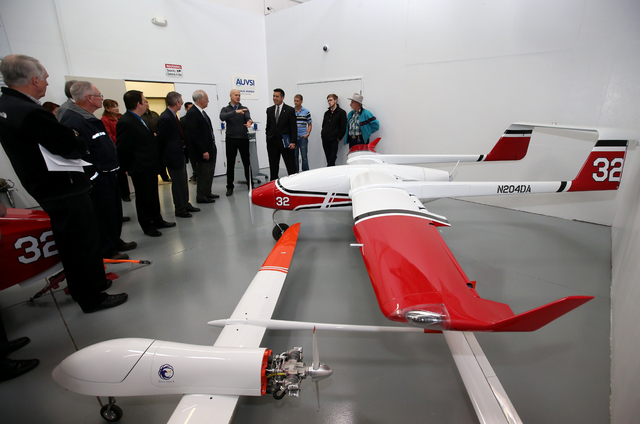 Drone America founder Mike Richards, center, talks with Nevada Gov. Brian Sandoval and local business representatives during a Cabinet Business Visit Day stop, in Reno, Nev., on Thursday, Dec. 5, ...