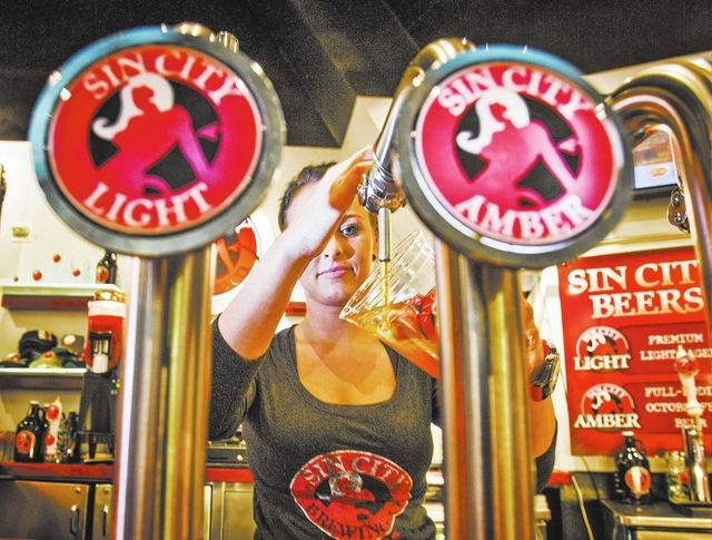 Egle Vaitiekute pours a beer at Sin City Brewery inside the Miracle Mile Shop at The Planet Hollywood, 3667 South Las Vegas Boulevard, on Wednesday, Jan. 15, 2014. Some businesses use the monike ...