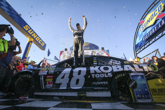 Jimmie Johnson celebrates in Victory Lane after winning the NASCAR Sprint Cup Series auto race Sunday, Sept. 29, 2013, in Dover, Del. (AP Photo/The News-Journal, Suchat Pederson)