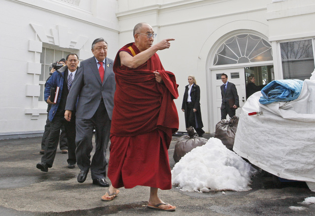 FILE - In this Feb. 18, 2010, file photo, The Dalai Lama walks out of the White House in Washington, after meeting with President Barack Obama. Obama will host Tibetan spiritual leader the Dalai L ...