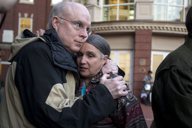 William Quigley and Michele Naar-Obed hug outside the Federal Courthouse after Naar-Obed's husband, Greg Boertje-Obed and two others were sentenced for the role they played in a July 2012 break-in ...