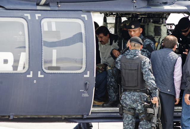 Joaquin "El Chapo" Guzman sits inside a federal police helicopter at a navy hanger in Mexico City, Saturday, Feb. 22, 2014. A senior U.S. law enforcement official said Saturday, that Guz ...