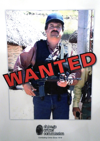 FILE - In a Thursday, Feb. 14, 2013, file photo, a poster displayed at a Chicago Crime Commission news conference in Chicago, shows Joaquin ``El Chapo'' Guzman, who was deemed Chicago's Public Ene ...