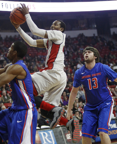 UNLV's Deville Smith shoots over Boise State's Derrick Marks (2) and Nicholas Duncan (13) during their basketball game at the Thomas & Mack Center in Las Vegas on Saturday, Feb. 1, 2014. (Jason Be ...