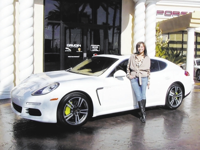 Courtesy photo Tina Eschweiler stands next to her 2014 Panamera electric plug-in hybrid.