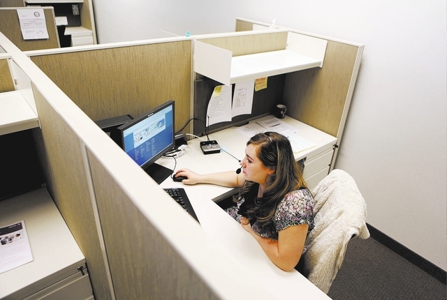 Amanda Schlichtenmyer, looks through Nevada Health Link training materials in between taking calls at Silver State Health Insurance Exchange call center Tuesday, Sept. 24, 2013, in Henderson. Staf ...