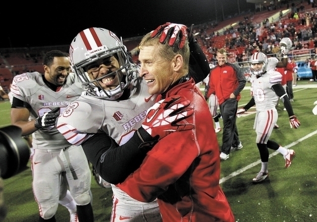 UNLV head coach Bobby Hauck celebrates a victory with one of his players (File/Las Vegas Review-Journal)