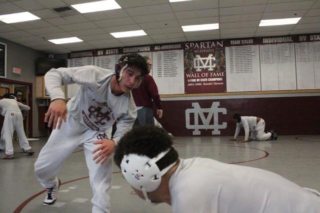 Defending state champion Angel Laurente, left, works with teammate Logan Marx-Hamilton as he ...