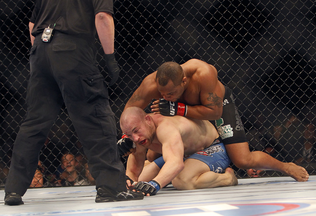 Daniel Cormier, top, pounds on Patrick Cummins to win by TKO during UFC 170 at the Mandalay Bay Events Center in Las Vegas on Saturday night, Feb. 22, 2014.  (Jason Bean/Las Vegas Review-Journal)