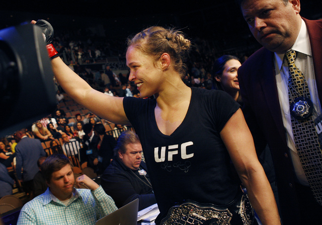 Ronda Rousey celebrates after defeating Sara McMann during UFC 170 at the Mandalay Bay Events Center in Las Vegas on Saturday night, Feb. 22, 2014. Rousey retained her Women's Bantamweight title b ...