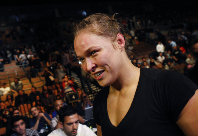 Ronda Rousey leaves the arena after defeating Sara McMann during UFC 170 at the Mandalay Bay Events Center in Las Vegas on Saturday night, Feb. 22, 2014. Rousey retained her Women's Bantamweight t ...