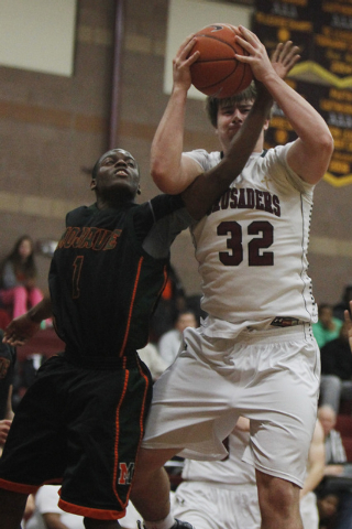 Mojave’s Melvin Irvey (1) tries to steal the ball from Faith Lutheran’s John Mol ...