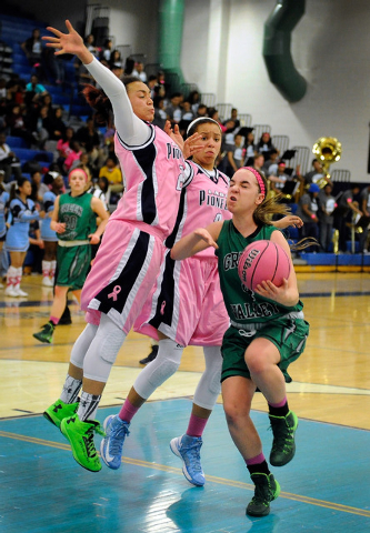Green Valley’s Ellee Barton is double teamed by Canyon Springs’ Daijhan Cooks, l ...