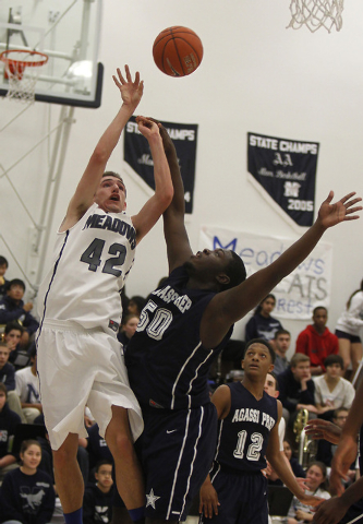The Meadows’ Brandon Rufty (42) shoots over Agassi Prep’s Wa’T Manor (50) ...