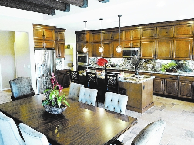 Courtesy photo An island kitchen highlights the 2,741-square-foot Plan Four model home at Series II at Tivoli in Mountain Falls by William Lyon Homes.