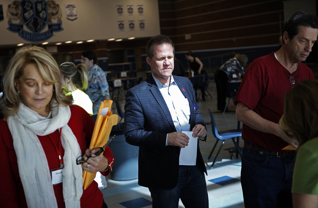 GOP lieutenant governor candidate Mark Hutchison, center, attends a precinct meeting in Las Vegas Saturday, Feb. 22, 2014. (John Locher/Las Vegas Review-Journal)