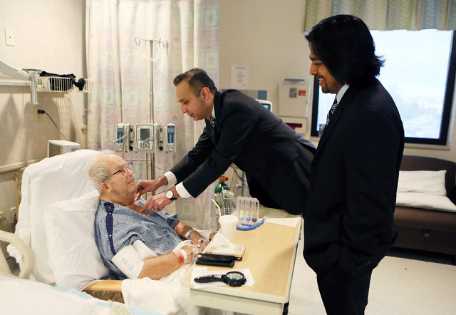 Patient Milton Knauer, 85, from left, receives a visit from his doctors Dr. Nauman Jahangir (cq), left, chief of cardiology at Sunrise Hospital & Medical Center, and Dr. Branavan Umakanthan (cq),  ...