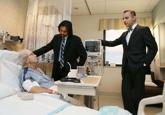 Patient Milton Knauer, 85, from left, receives a visit from his doctors Dr. Branavan Umakanthan (cq), cardiologist, and Dr. Nauman Jahangir (cq), left, chief of cardiology at Sunrise Hospital and  ...