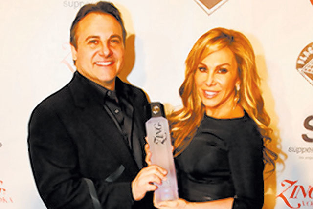 George Maloof and sister Adrienne hoist the family’s Zing vodka. (Courtesy)