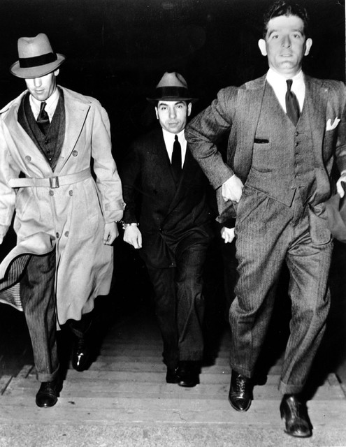 Charles "Lucky" Luciano, center, is escorted into court by two detectives on June 18, 1936. Luc ...