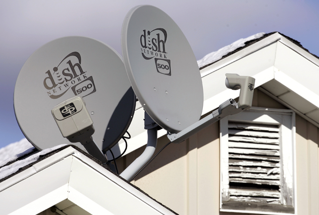 In this Nov. 10, 2008 file photo, Dish Network Corp. satellite dishes are attached to a home in Buffalo, N.Y.  Dish Network and Disney have reached a landmark deal Tuesday, March 4, 2014,  that en ...