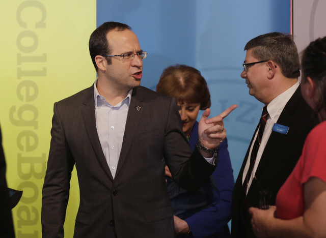 College Board President David Coleman, left, attends an announcement event, Wednesday, March 5, 2014, in Austin, Texas where College Board officials announced updates for the SAT college entrance ...