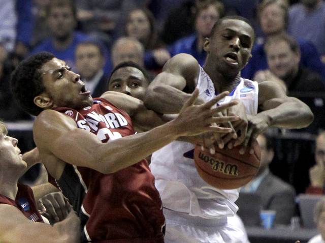 Kansas' Andrew Wiggins, right, and Stanford's Josh Huestis reach for a rebound during game in the NCAA college basketball tournament Sunday in St. Louis. Stanford won, 60-57. (AP Photo/Jeff Roberson)
