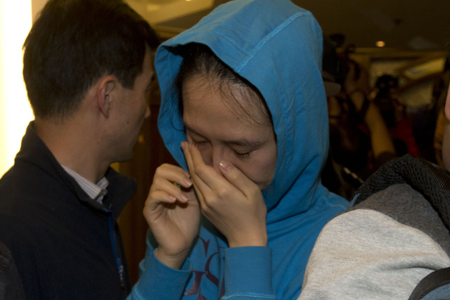 A relative of a Chinese passenger aboard the Malaysia Airlines MH370 cries after being told the latest update in Beijing on Monday. (AP Photo/Ng Han Guan)