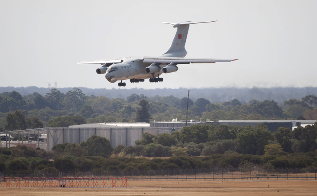 A Chinese IL-76 plane searching for the missing Malaysia Airlines Flight MH370 returns to Perth airport, in Australia after a hunting sortie, Monday. A Chinese plane on Monday spotted two white, s ...