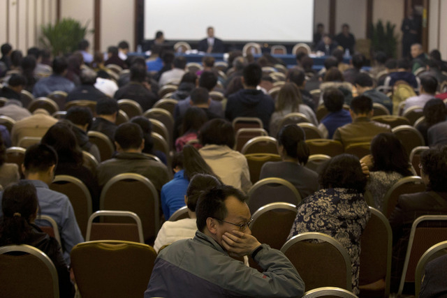 Relatives of Chinese passengers aboard the missing Malaysia Airlines flight MH370 attend a meeting with the Malaysian ambassador to China and a representative of Malaysia Airlines in Beijing on Mo ...