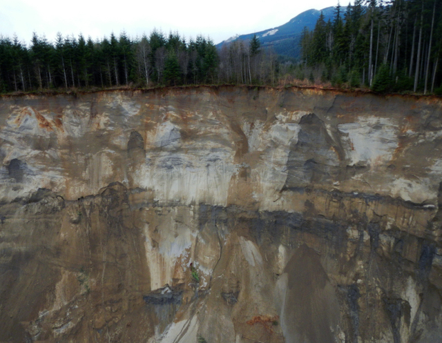 A view of the damage from Saturday's mudslide near Oso, Wash. At least eight people were killed in the 1-square-mile slide that hit in a rural area about 55 miles northeast of Seattle. Several peo ...