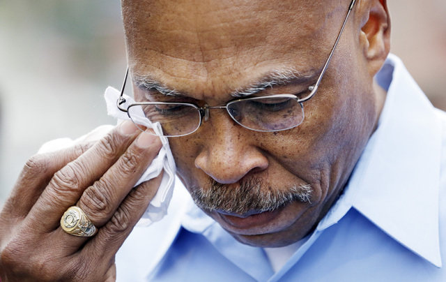 Snohomish County Executive John Lovick wipes his eyes Monday as he listens during a news conference about a deadly mudslide that happened Saturday in Arlington, Wash. The search for survivors of t ...