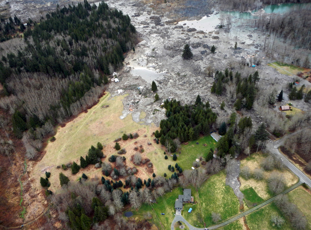 A view of the damage from Saturday's mudslide in Oso, Wash. At least eight people were killed in the 1-square-mile slide that hit in a rural area about 55 miles northeast of Seattle. Several peopl ...
