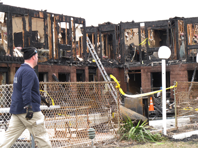 Investigators go through the rubble of a motel in Point Pleasant Beach N.J., on Saturday, March 22, 2014.  Autopsies were being conducted Saturday on the four people who died in a fire at a Jersey ...