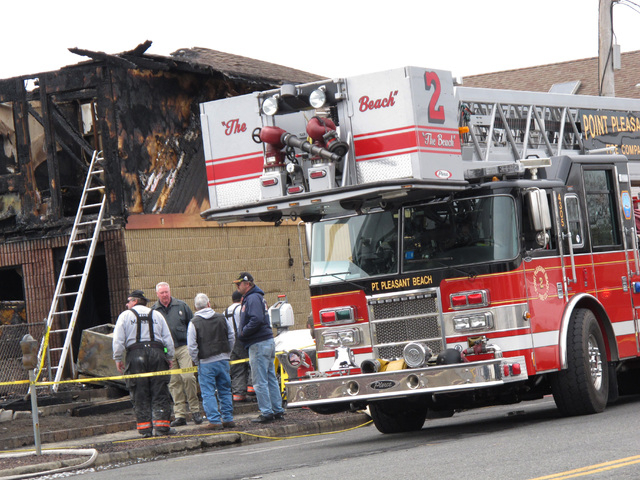 Investigators examine the remains of a motel in Point Pleasant Beach N.J., on Saturday, March 22, 2014.  Autopsies were being conducted Saturday on the four people who died in a fire at a Jersey s ...
