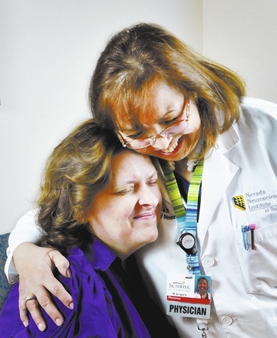 Dr. M. Gabriela Gregory, right, hugs patient Nancy Buckley after injecting her with Botox to help treat Buckley's migraine headaches at the Nevada Neurosciences Institute at 3131 La Canada St. in  ...