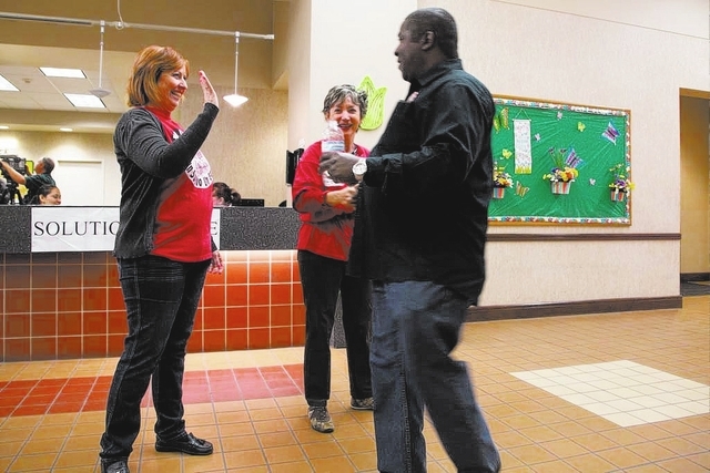 Culinary Workers Union, Local 226 staff members (names withheld) show their support and guide members to the meeting sign-in table at the East Las Vegas Community Center on Thursday, March 27, 201 ...