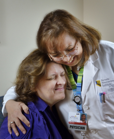 Dr. M. Gabriela Gregory, right, hugs patient Nancy Buckley after injecting her with Botox to help treat Buckley's migraine headaches at the Nevada Neurosciences Institute at 3131 La Canada St. in  ...