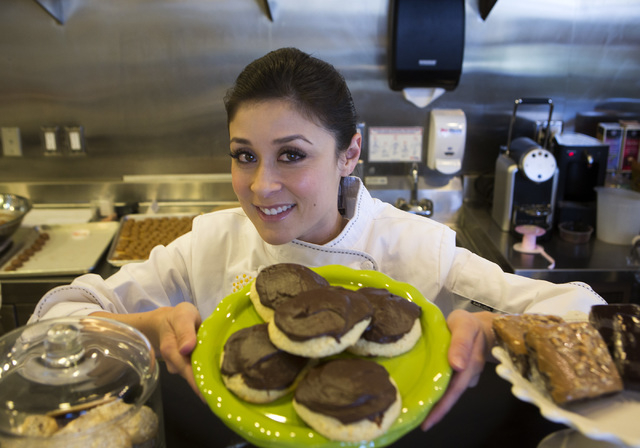 Tiffany Jones, baker and owner of Peridot Sweets, 6475 S. Rainbow Boulevard, with a plate of cookies with chocolate frosting on Friday, March 14, 2014. 
(Jeff Scheid/Las Vegas Review-Journal)
