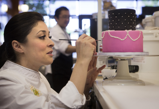 Tiffany Jones, baker and owner of Peridot Sweets, 6475 S. Rainbow Boulevard, details a cake on Friday, March 14, 2014.  
(Jeff Scheid/Las Vegas Review-Journal)