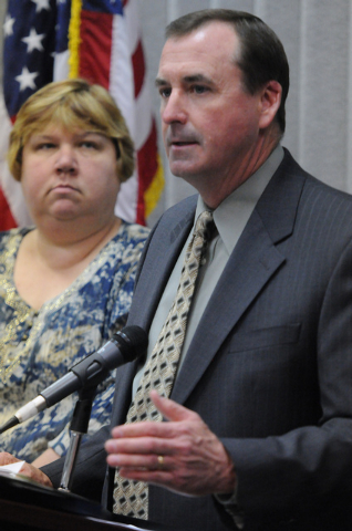 Clark County School District Trustee Deanna L. Wright, left, watches Las Vegas police Capt. Brett Primas speak during a press conference on an ongoing investigation of misuse of public funds at th ...