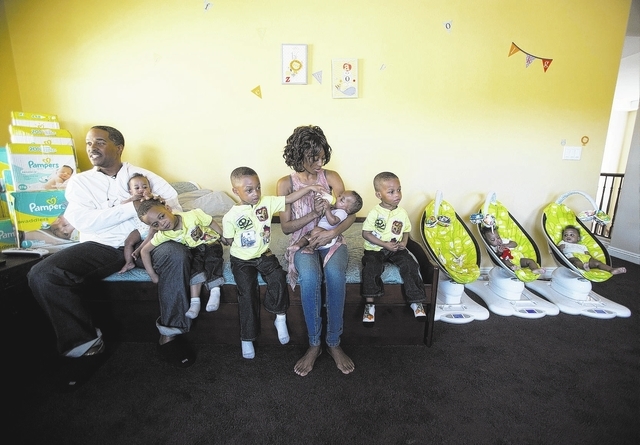 Deon Derrico,left, and his wife Evonne with their seven of their nine children at their home in North Las Vegas on Monday, March 24, 2014. Evonne Derrico gave birth to quintuplets on Sept. 6.(Jeff ...