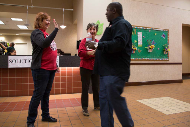 Culinary Workers Union, Local 226 staff members (names withheld) show their support and guide members to the meeting sign-in table at the East Las Vegas Community Center on Thursday, March 27, 201 ...