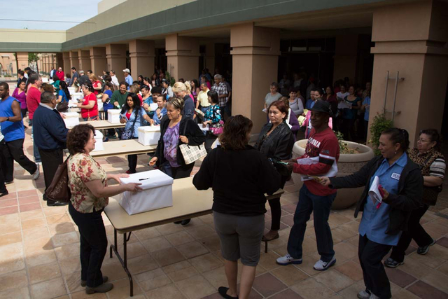 Culinary Workers Union, Local 226 members flood from the meeting hall into the courtyard to cast their ballots at the East Las Vegas Community Center on Thursday, March 27, 2014. Both culinary wor ...